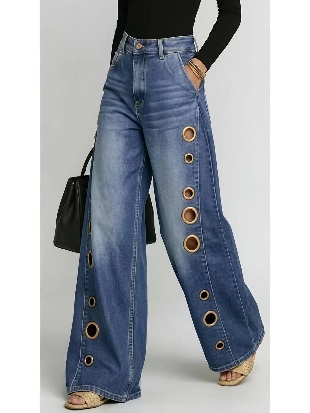 Retro-style wide-leg jeans with metallic eyelets, high-waisted, loose, floor-length fit, gradient eyelets of varying sizes on both sides, distressed washed finish, classic front and back pockets, perfect for everyday casual w